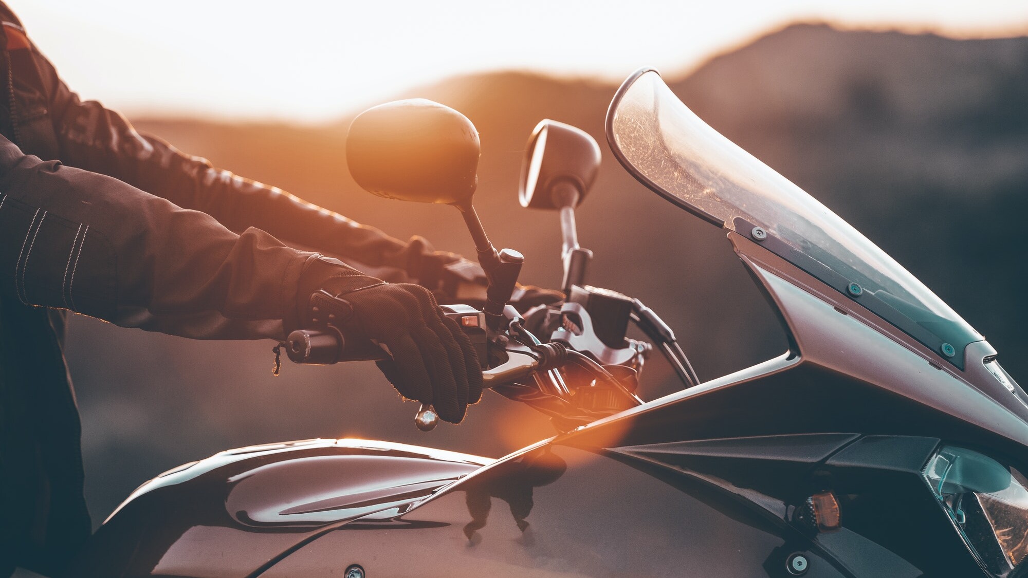 Biker hand rests on the steering wheel motorcycle