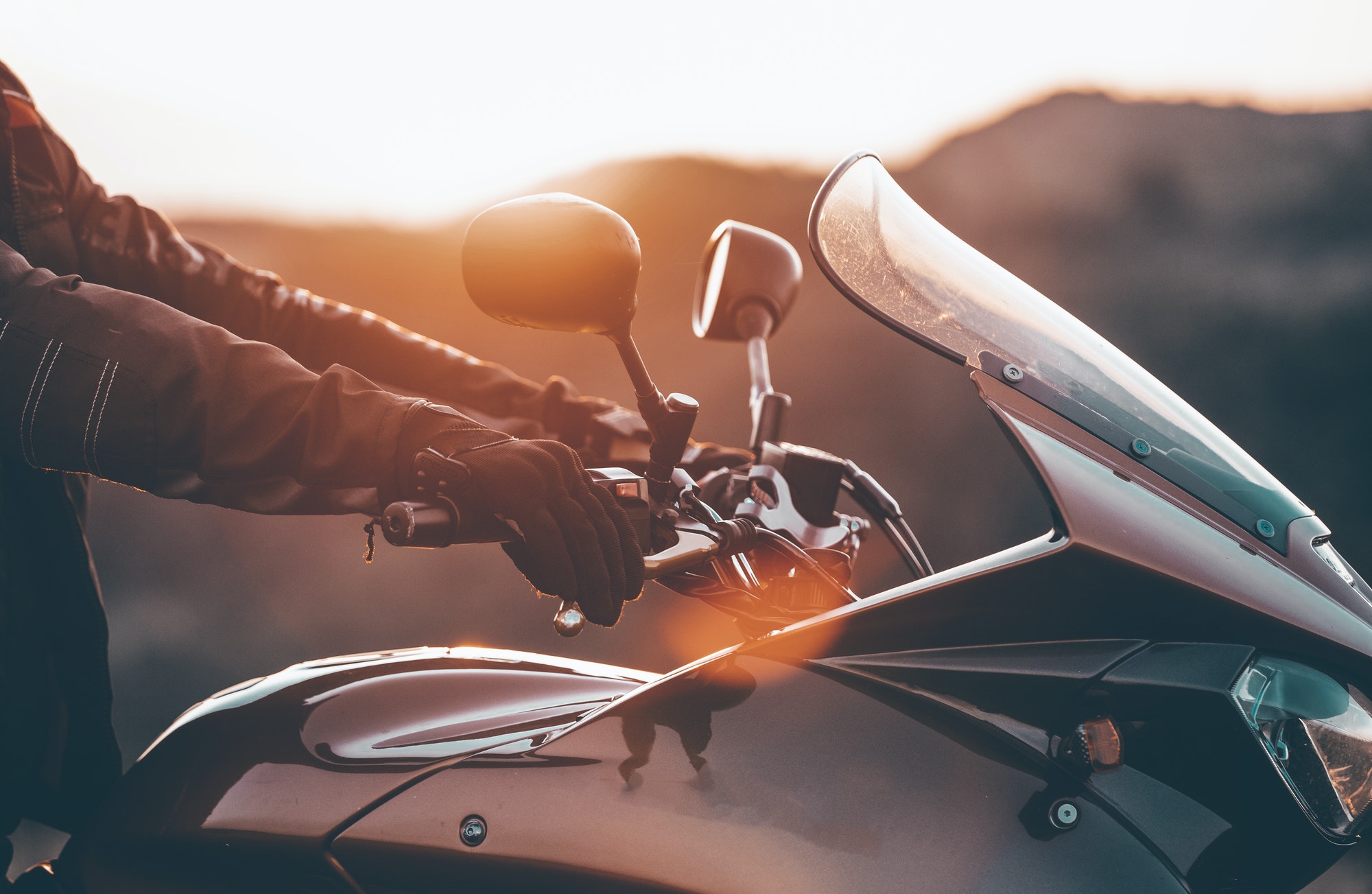 Biker hand rests on the steering wheel motorcycle
