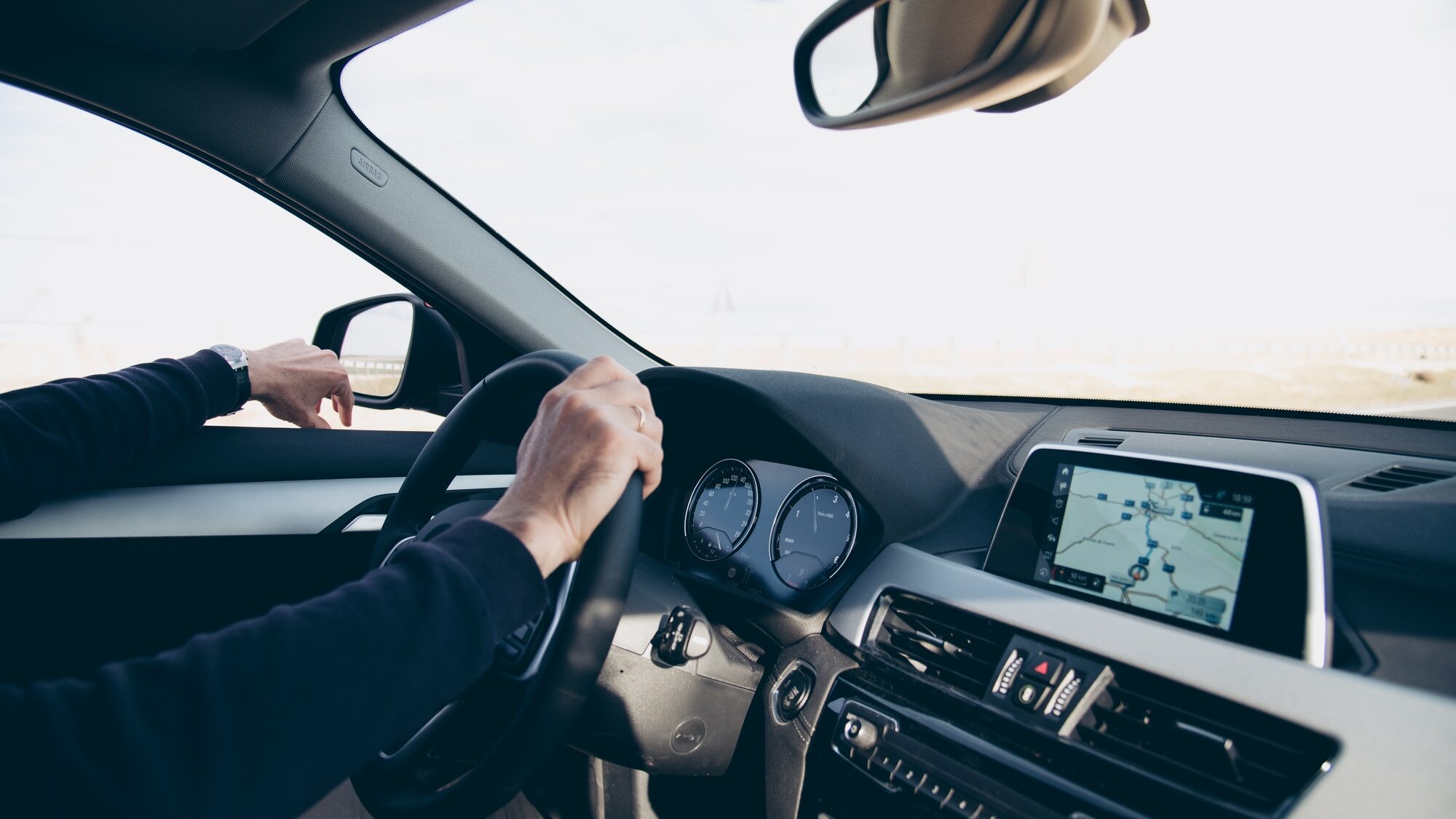 Side view of man driving car with navigation GPS